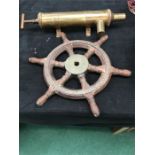 A brass pump and an oak ship's wheel.