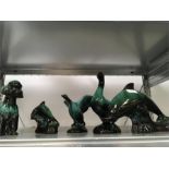 A collection of five green glazed terracotta animals and a vase.