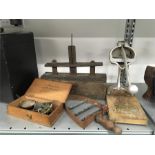 A vintage Instant juice press together with a set of scales, antique oak mouse trap and iron plate.