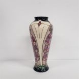 Moorcroft: An 8" vase in the Foxglove pattern. Impressed marks to the base.