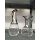 Two silver plated topped glass decanters.