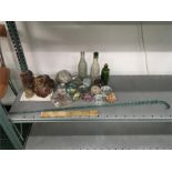 A decorative glass walking stick together with 14 glass paperweights, glass bottles, soapstone