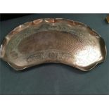 A large copper tray and a pair of metal curtain poles and rings.