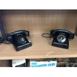 Two black vintage telephones, with Arabic numbers