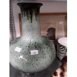 A large high fired runny green glazed lamp vase and a print of a Dorset country scene. signed