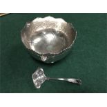 A silver plated punch bowl and ladle.