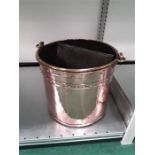 A large copper coal bucket.