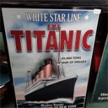 A large metal sign depicting the Titanic.