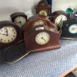 A collection of wooden vintage clocks.