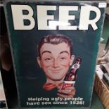 A large metal sign depicting Beer.