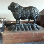 A metal doorstop depicting a Ram.