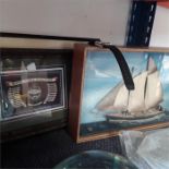 A small diorama of a yacht, two pictures one depicting the Royal Tank Regiment and a watch.