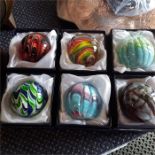 Six small paperweights.