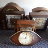 A collection of wooden mantle clocks.