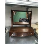 A Victorian mahogany toilet mirror with trinket drawers.