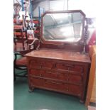 An oak four drawer dressing chest with vanity mirror to top.