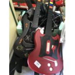 Two toy guitars, with headphones and cables.