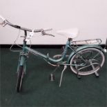 A Hercules folding bike. Three speed with mudguards, a stand, rack and pump. A few signs of rust, in