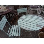 A folding bistro table with two chairs.