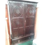 An oak double wardrobe with single drawer to base.