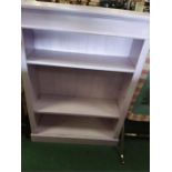 A painted open bookcase.