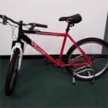 An Apollo mountain bike. 21 speed with front suspension and mechanical disc brakes. Missing cable