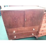 An oak two drawer cabinet with two doors to top.