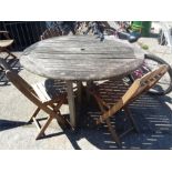 A teak folding table with three chairs.