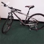 A GT mountain bike. 24 speed with front suspension, mechanical disc brakes and a bell. Some