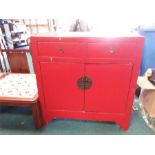 A Chinese style two door cabinet with two drawers above.