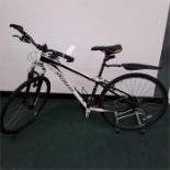 A Specialized mountain bike. 24 speed with front suspension and a rear mudguard. Some damage to