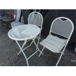 A metal bistro table with two chairs.