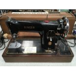 A Singer sewing machine, plus a Silver Reed electric typewriter.