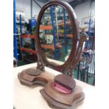 An oak vanity mirror with two hinged trinket boxes.