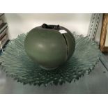 A large green glass bowl and an art pottery flared lip vase.