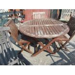 A circular folding garden table with three chairs.