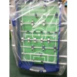 A plastic football table on legs.