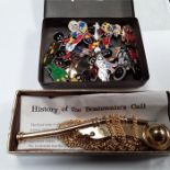 A tin containing a quantity of Golly badges together with a Boatswains's whistle.