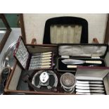 A suitcase containing four cutlery collections, a pair of binoculars, a jewellery display case and