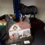 A cast iron doorstop of a farmyard scene together with a Ram.