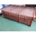 A wood bound travel trunk.