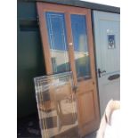 A glazed double panel exterior door together with a matching glass panel.