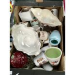 A box of royal memorabilia mugs and other china.