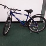 A Raleigh mountain bike. 21 speed with front suspension and mudguards. Some signs of rust and