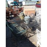 A metal garden table with four chairs.