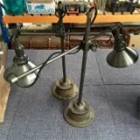 A pair of industrial anglepoise lamps.