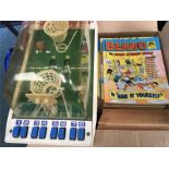 A collection of Beano comics with a toy basketball game.