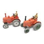 Two Dinky 27n/ 301 Field Marshall Tractors, both in orange with tan driver and metal wheels, one