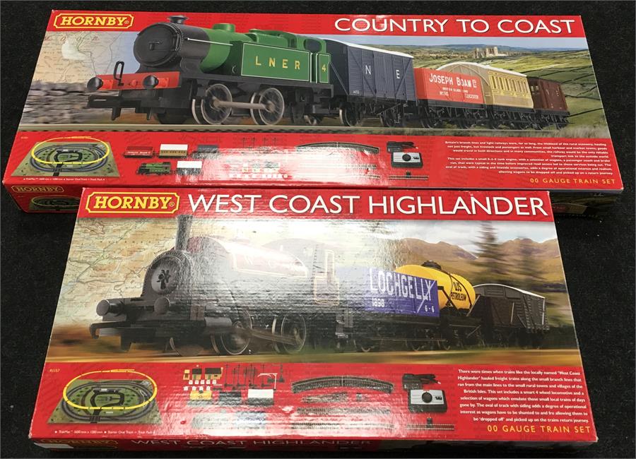 Two Hornby sets: R1201 Country To Coast; R1157 West Coast Highlander (missing one wagon). Appear F