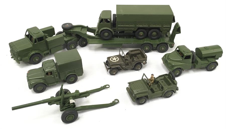 Seven Dinky Toys military models, includes 660 Tank Transporter and 641 Army Truck with figures.